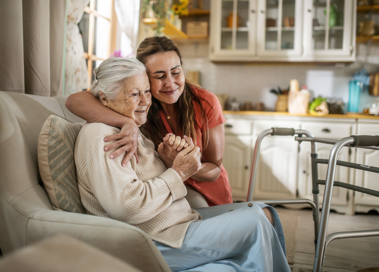 A caregiver assisting an older adult at home